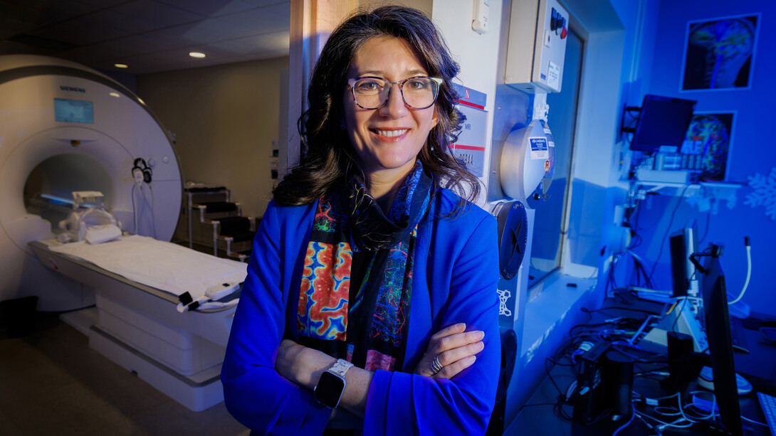 Dr Maital Neta in front of an MRI